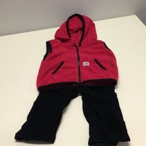 Carhartt sleeveless fleece hoodie and black corduroy pants
